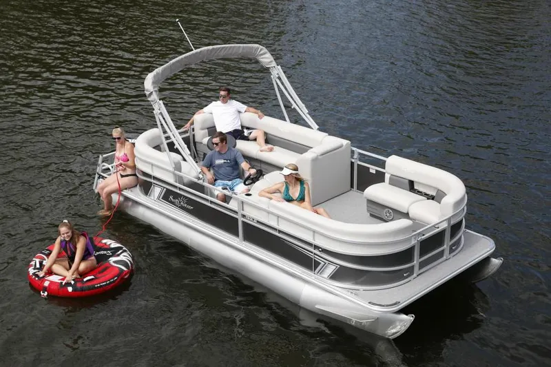 Slide: The Image of Manufacturer Provided Image: 2021 SunChaser Vista 20 LR pontoon boat with people relaxing and tubing on a lake. - 6