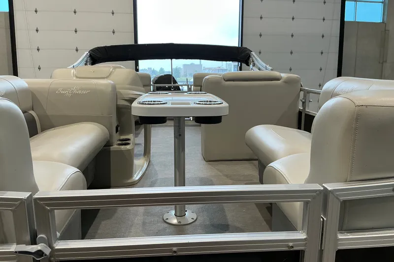 Slide: The Image of Interior of 2021 SunChaser Vista 20 LR pontoon boat with beige seating and table. - 17