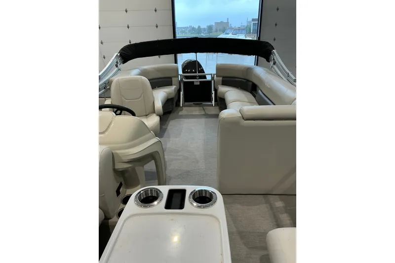 Slide: The Image of Interior of 2021 SunChaser Vista 20 LR pontoon boat with beige seating and cup holders. - 19