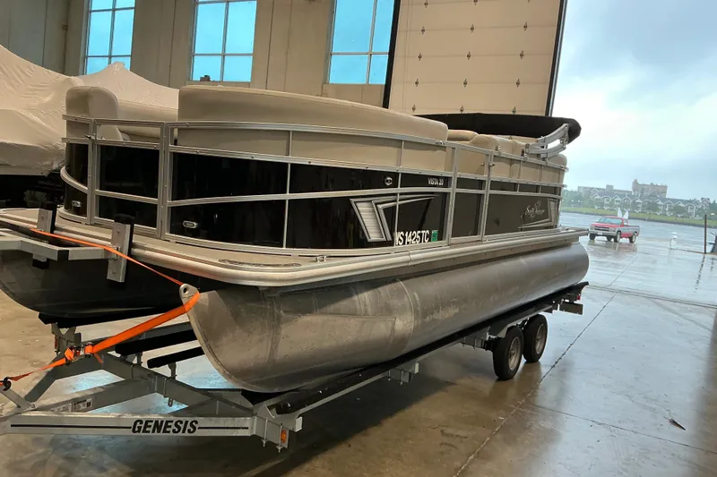 Slide: The Image of 2021 SunChaser Vista 20 LR pontoon boat on trailer in indoor storage facility. - 13