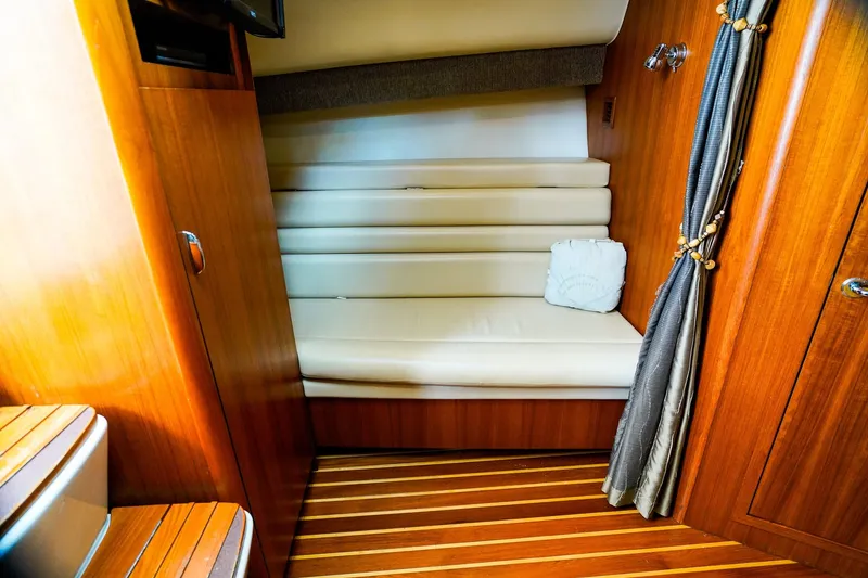 Slide: The Image of 2005 Tiara Yachts 3800 Open interior with wooden finish and cushioned seating. - 29