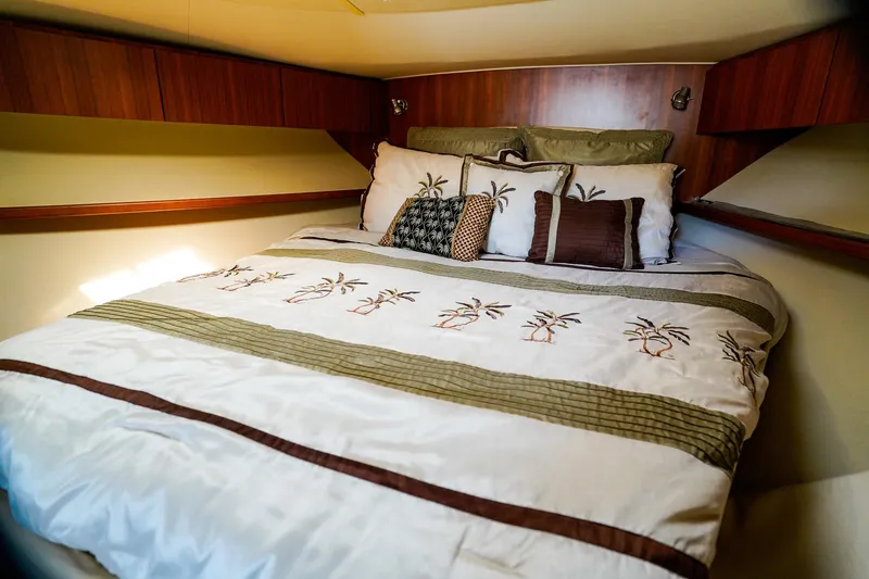 Slide: The Image of Cozy bedroom in 2005 Tiara Yachts 3800 Open with palm-themed bedding. - 31