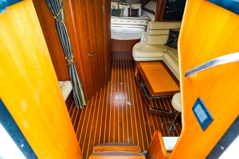 Slide: The Image of Luxurious interior of 2005 Tiara Yachts 3800 Open with wood flooring and cozy seating. - 23