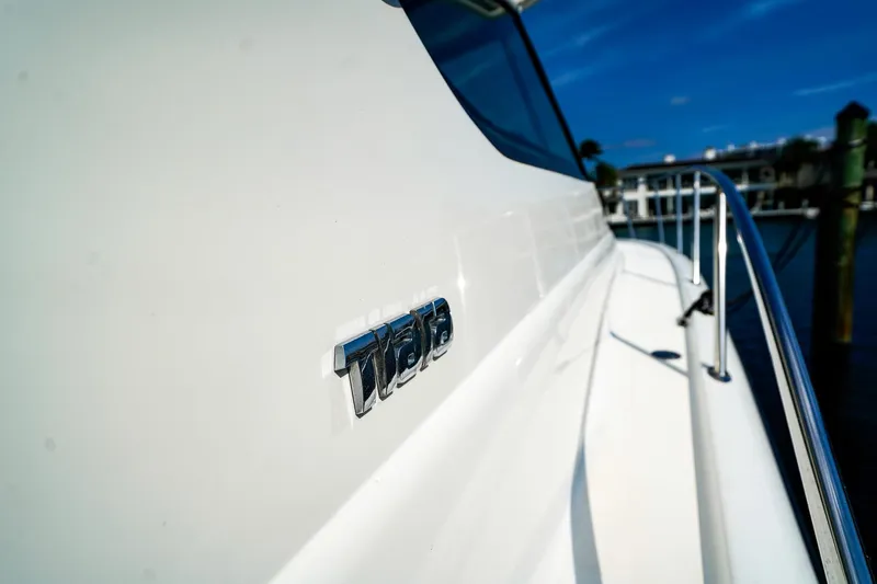 Slide: The Image of 2005 Tiara Yachts 3800 Open, close-up of logo on sleek white exterior. - 35
