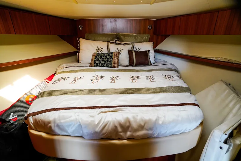 Slide: The Image of Cozy bedroom interior of 2005 Tiara Yachts 3800 Open with palm-themed bedding. - 30