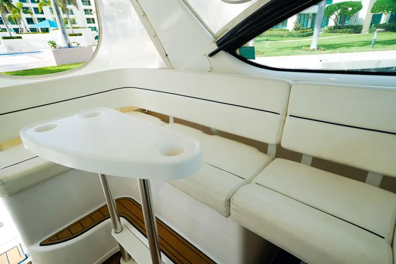 Slide: The Image of Interior of 2005 Tiara Yachts 3800 Open with white seating and table. - 18