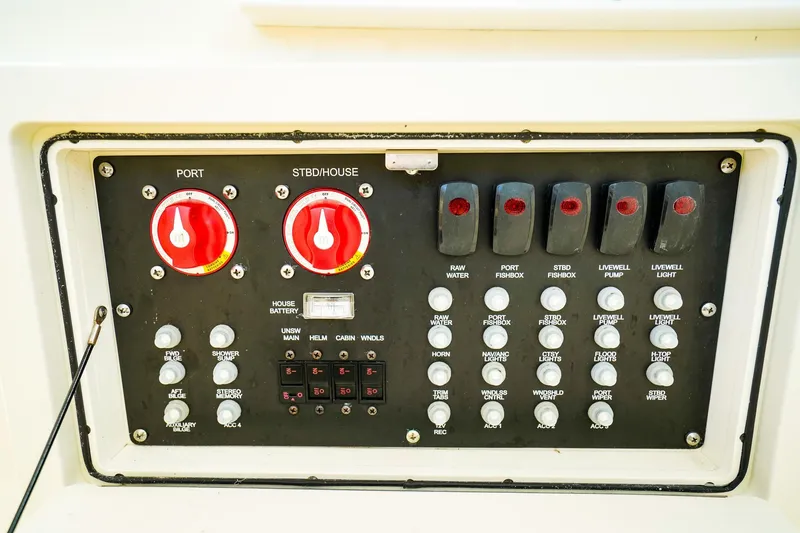 Slide: The Image of Control panel of a 2018 Boston Whaler 315 Conquest boat with switches and dials. - 31