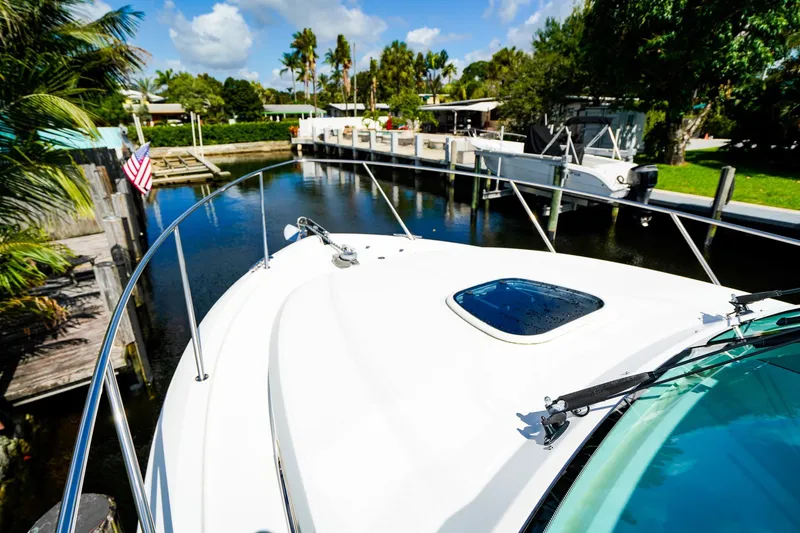 Slide: The Image of 2018 Boston Whaler 315 Conquest docked in a scenic waterfront setting. - 30