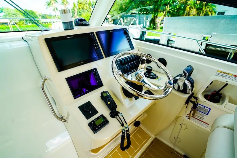 Slide: The Image of Helm of 2018 Boston Whaler 315 Conquest with advanced navigation systems and controls. - 16