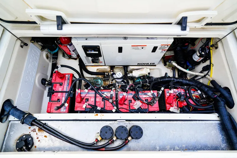 Slide: The Image of Engine compartment of a 2018 Boston Whaler 315 Conquest with Kohler generator and batteries. - 32