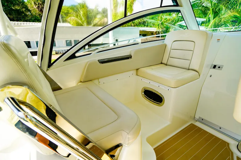 Slide: The Image of 2018 Boston Whaler 315 Conquest interior with beige seating and sleek design. - 13