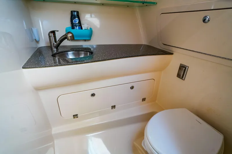 Slide: The Image of 2018 Boston Whaler 315 Conquest bathroom with sink, faucet, and toilet. - 22