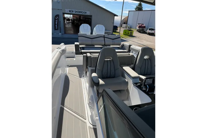 Slide: The Image of 2027 Monterey Elite 30 OB boat interior with luxurious seating, showcased in a showroom setting. - 17
