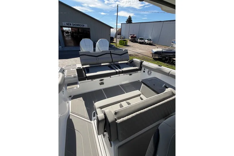 Slide: The Image of 2027 Monterey Elite 30 OB boat interior with seating, showcased at a dealership. - 8