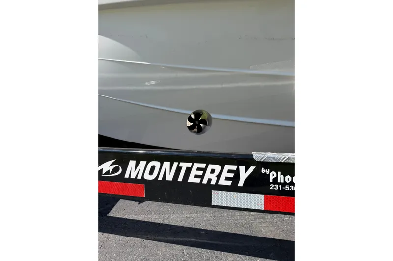 Slide: The Image of 2027 Monterey Elite 30 OB boat on trailer, showcasing sleek hull design. - 3