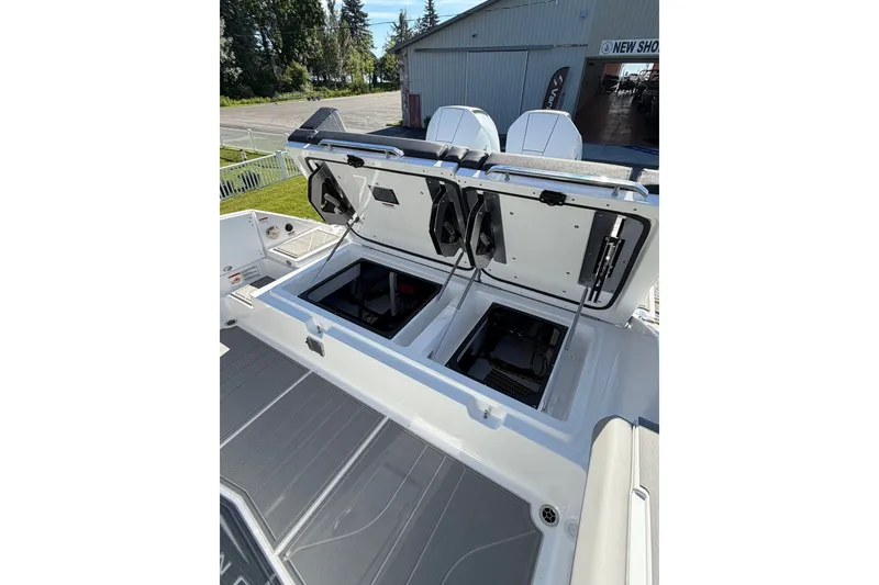 Slide: The Image of 2027 Monterey Elite 30 OB boat with open storage compartments, showcasing modern design and functionality. - 9
