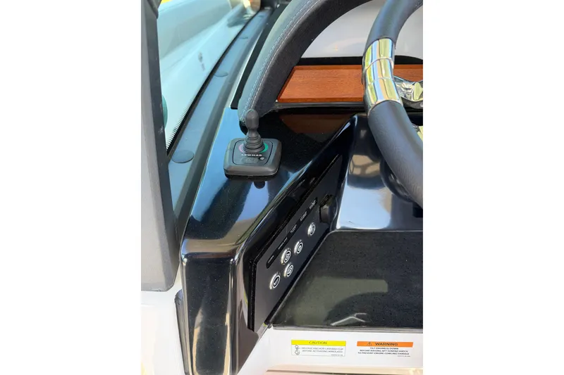 Slide: The Image of Dashboard of 2027 Monterey Elite 30 OB boat with joystick and steering wheel. - 15