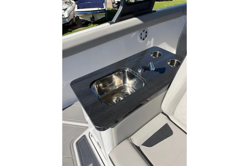 Slide: The Image of Luxury sink area on 2027 Monterey Elite 30 OB boat, featuring sleek design and cup holders. - 12