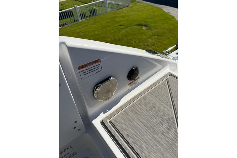 Slide: The Image of 2027 Monterey Elite 30 OB boat deck with warning label and control panel. - 20