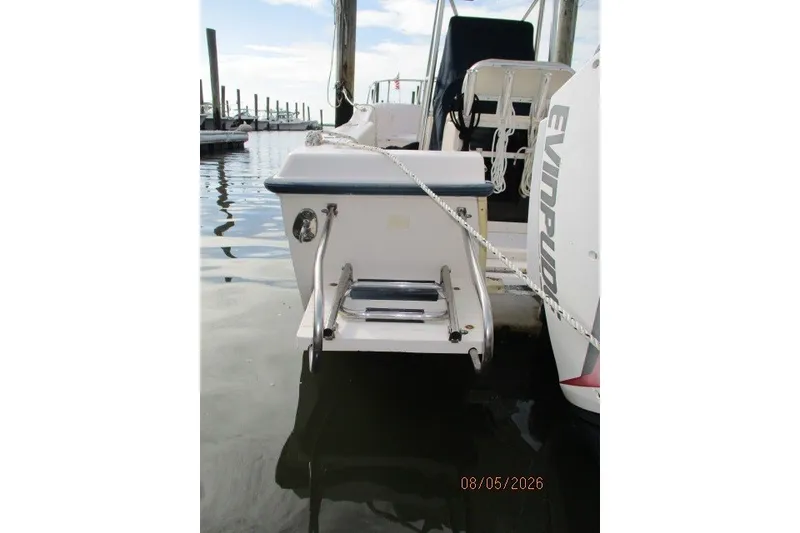 Slide: The Image of 2000 Grady-White Escape 209 boat docked with Evinrude motor, rear view. - 56