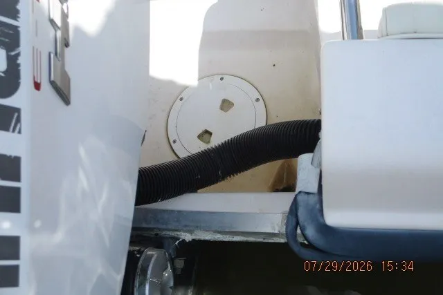 Slide: The Image of Grady-White Escape 209 boat interior, showing engine compartment and hose, dated July 29, 2026. - 16