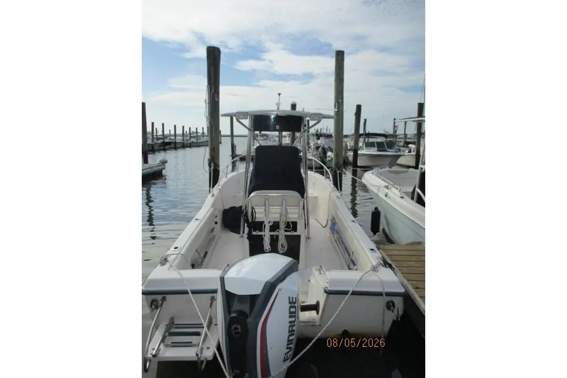 Slide: The Image of 2000 Grady-White Escape 209 boat docked with Evinrude outboard motor. - 58