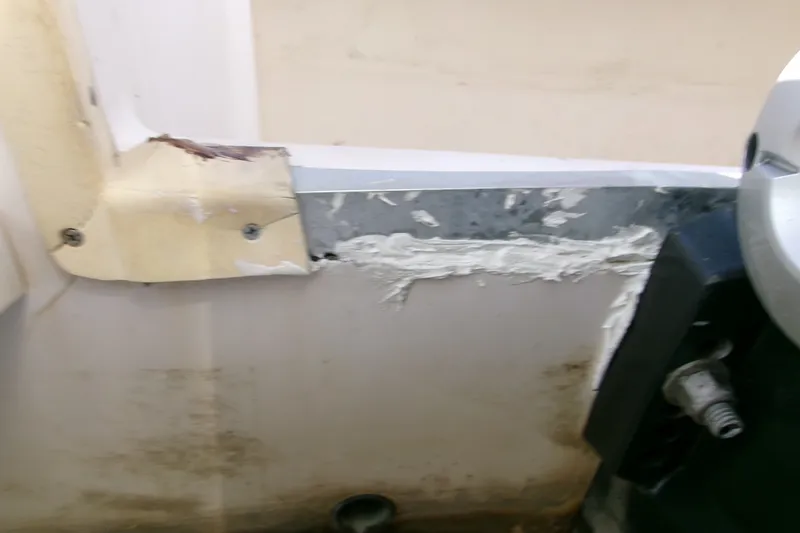 Slide: The Image of Close-up of a damaged Grady-White Escape 209 boat interior, showing wear and repair. - 9