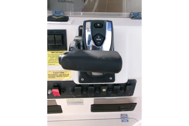 Slide: The Image of Control panel of a 2000 Grady-White Escape 209 boat with throttle and switches. - 5