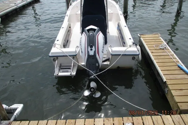 Slide: The Image of 2000 Grady-White Escape 209 boat docked with outboard motor visible. - 3