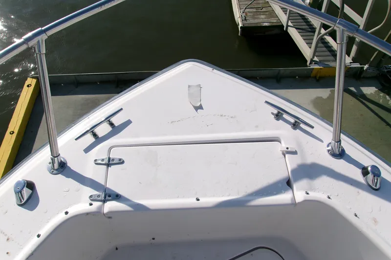 Slide: The Image of Bow of a 2000 Grady-White Escape 209 boat docked at a marina. - 42