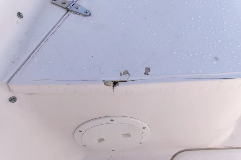 Slide: The Image of Damaged section of a 2000 Grady-White Escape 209 boat with visible wear and cracks. - 41