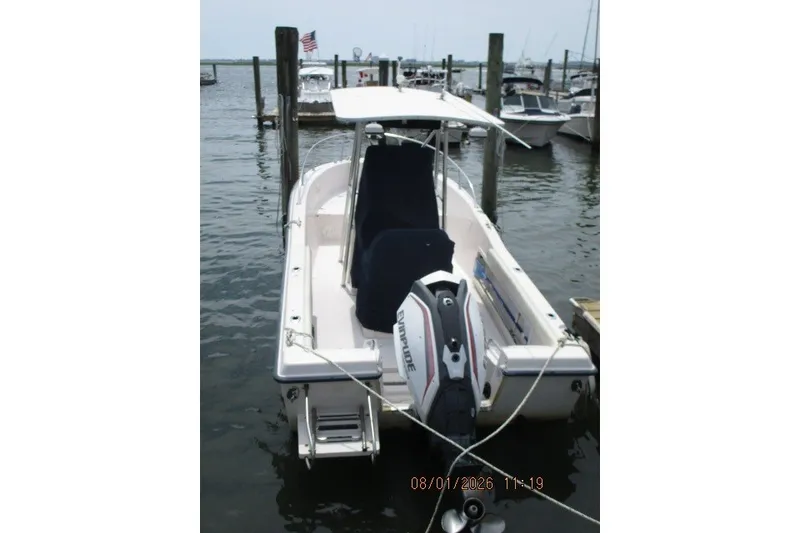 Slide: The Image of 2000 Grady-White Escape 209 boat docked with Evinrude outboard motor. - 18