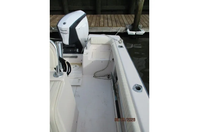 Slide: The Image of 2000 Grady-White Escape 209 boat interior with Evinrude 200 HP engine at dock. - 53