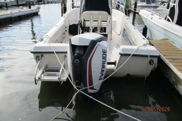 Slide: The Image of 2000 Grady-White Escape 209 boat with Evinrude motor docked at marina. - 55