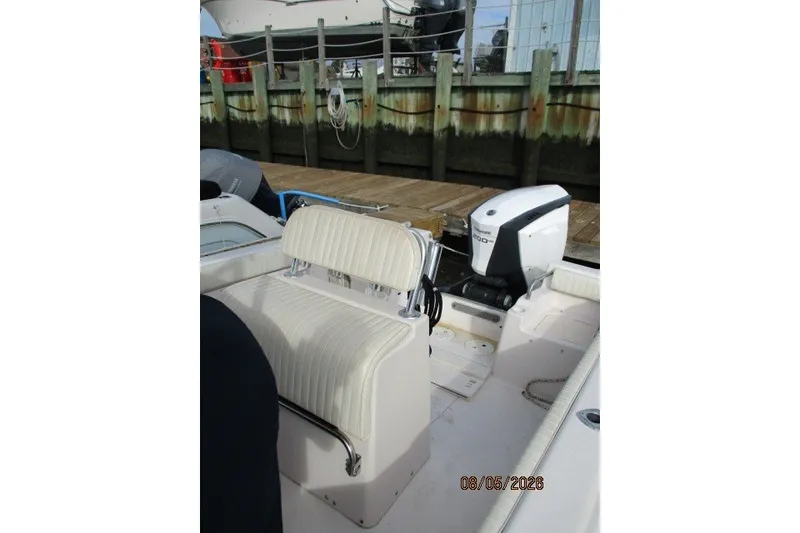 Slide: The Image of 2000 Grady-White Escape 209 boat with seating and outboard motor at dock. - 52