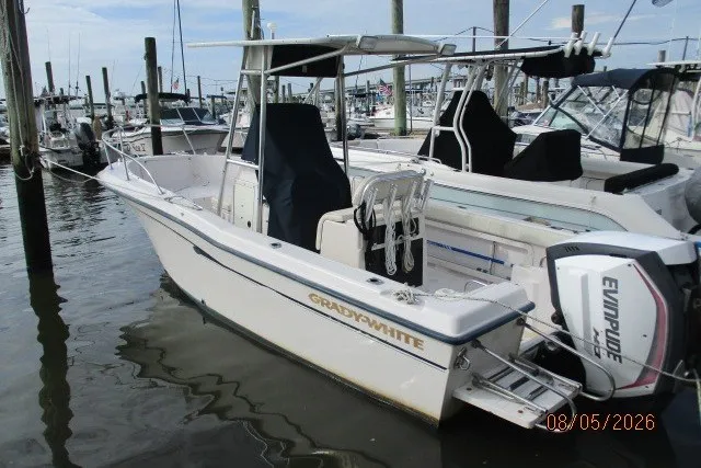 Slide: The Image of 2000 Grady-White Escape 209 boat docked with Evinrude outboard motor. - 59