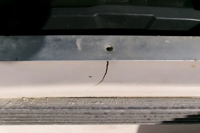 Slide: The Image of Crack on Grady-White Escape 209 boat, 2000 model, near metal fixture. - 48