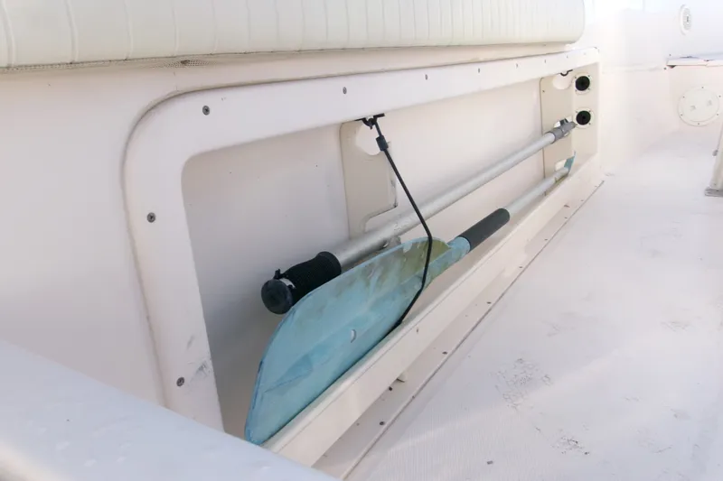 Slide: The Image of Storage compartment on a 2000 Grady-White Escape 209 boat with paddle and equipment. - 49