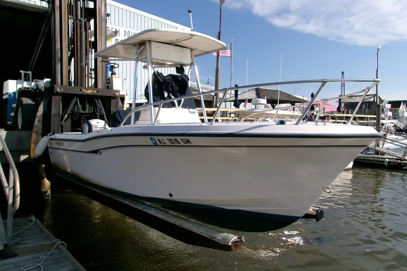 Slide: The Image of 2000 Grady-White Escape 209 boat docked at marina, clear sky background. - 22