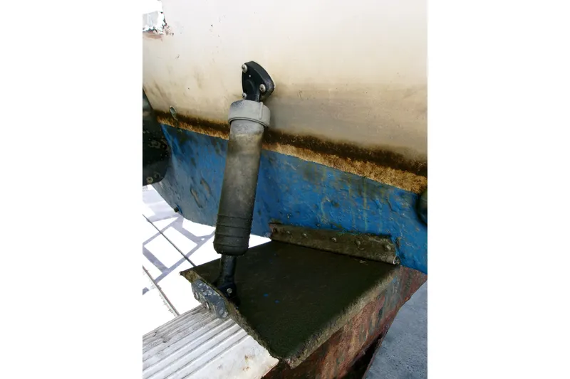 Slide: The Image of Close-up of a 2000 Grady-White Escape 209 boat's trim tab and hydraulic actuator. - 12