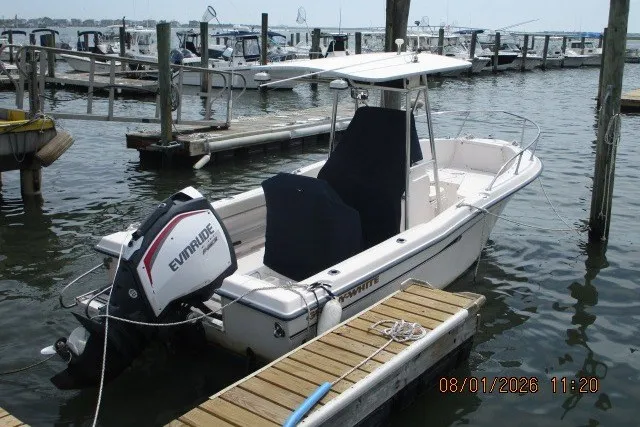 Slide: The Image of 2000 Grady-White Escape 209 boat docked with Evinrude outboard motor. - 1