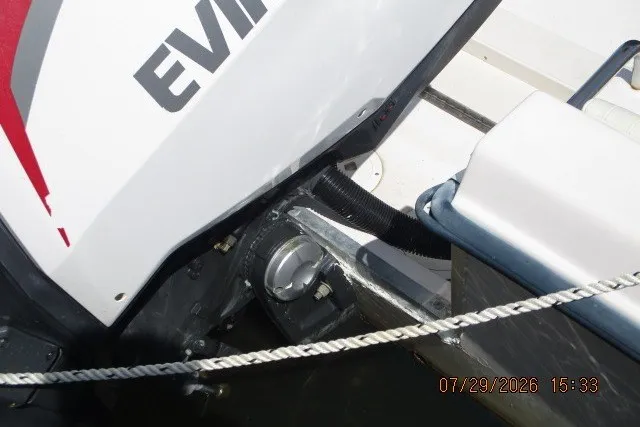 Slide: The Image of Outboard motor on a 2000 Grady-White Escape 209 boat, featuring Evinrude branding. - 14
