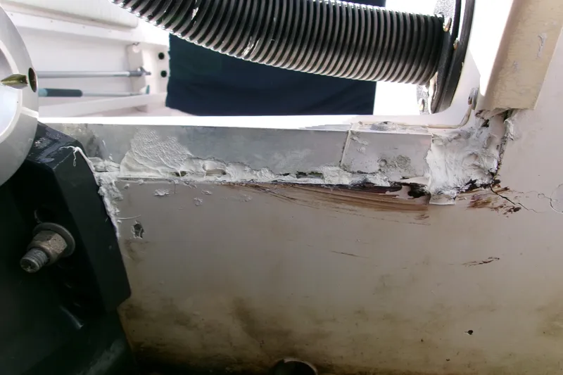 Slide: The Image of Close-up of damage on a 2000 Grady-White Escape 209 boat hull. - 15
