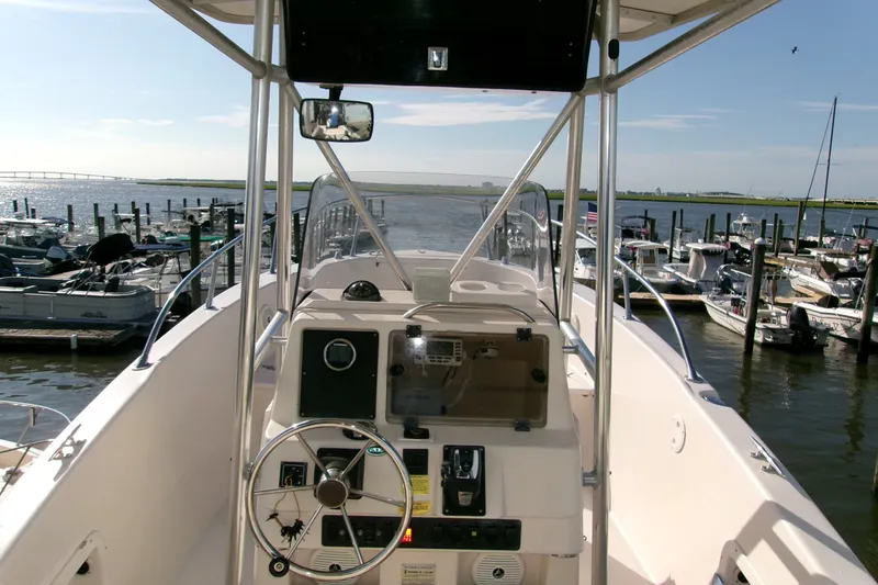 Slide: The Image of 2000 Grady-White Escape 209 boat at marina, steering console view. - 30