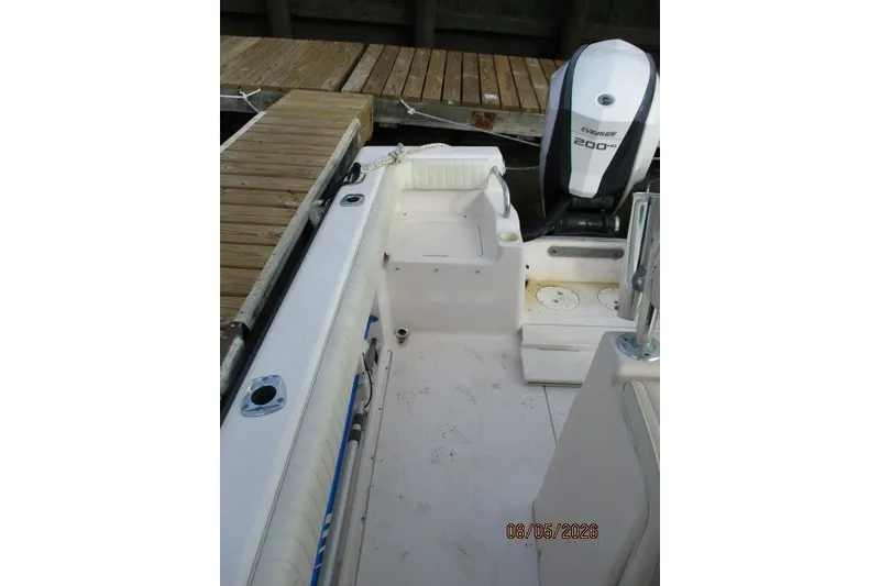 Slide: The Image of 2000 Grady-White Escape 209 boat interior with Evinrude 200 HP engine at dock. - 54