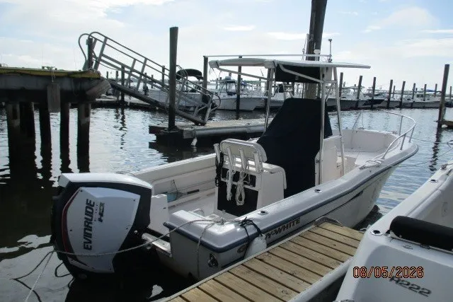 Slide: The Image of 2000 Grady-White Escape 209 boat docked with Evinrude motor, marina background. - 60