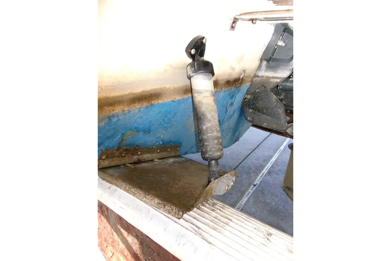 Slide: The Image of Close-up of 2000 Grady-White Escape 209 boat's trim tab and hydraulic actuator. - 11