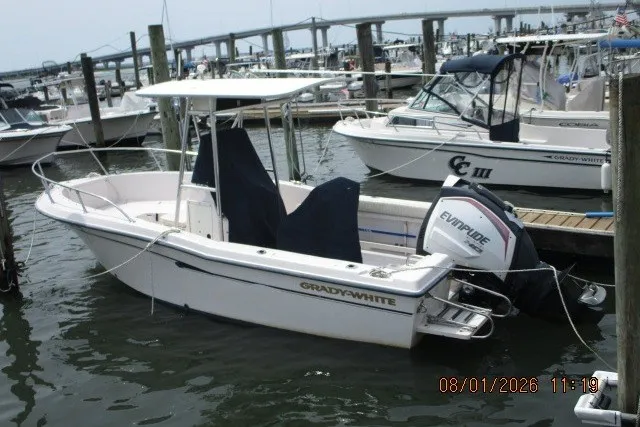The Image of 2000 Grady-White Escape 209 boat docked with Evinrude motor, marina background. - 0