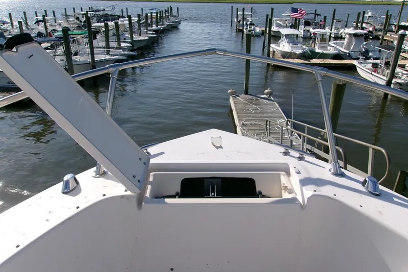 Slide: The Image of Bow view of 2000 Grady-White Escape 209 at marina with docked boats. - 43