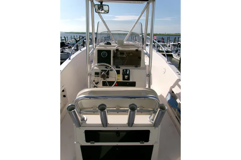 Slide: The Image of 2000 Grady-White Escape 209 boat interior with steering wheel and rod holders. - 33